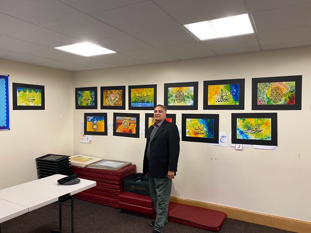 Smiling exhibition participant holding artwork